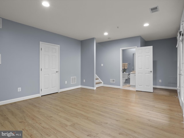 1473 Northern Neck Dr, Vienna, VA 22182 - empty room with stairway, recessed lighting, and light wood-style flooring