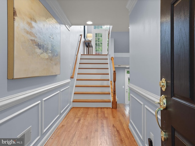 1473 Northern Neck Dr, Vienna, VA 22182 - stairs featuring wood finished floors, wainscoting, a decorative wall, and crown molding
