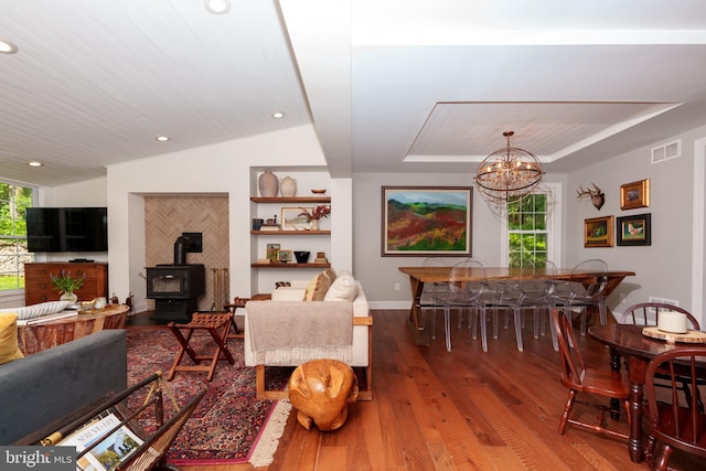 1032 N New St, West Chester, PA 19380 - living room featuring hardwood / wood-style floors, a wood stove, a chandelier, a raised ceiling, and recessed lighting