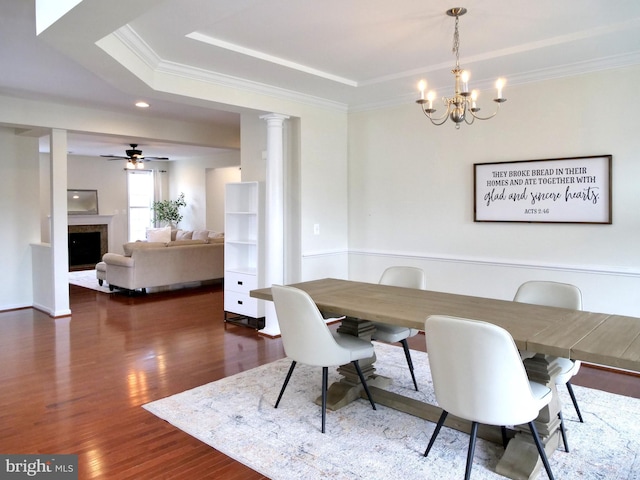 15152 Santander Dr, Gainesville, VA 20155 - dining space featuring a chandelier, wood finished floors, crown molding, a fireplace, and a tray ceiling