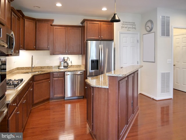 15152 Santander Dr, Gainesville, VA 20155 - kitchen with stainless steel appliances, recessed lighting, dark wood finished floors, a center island, and light stone countertops