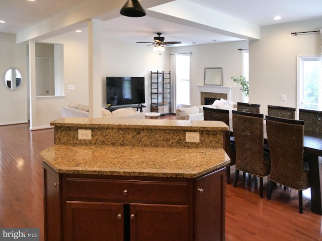 15152 Santander Dr, Gainesville, VA 20155 - kitchen featuring dark wood-style flooring, light stone countertops, a ceiling fan, dark brown cabinetry, and recessed lighting