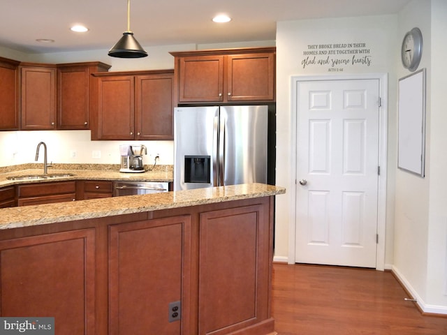 15152 Santander Dr, Gainesville, VA 20155 - kitchen with appliances with stainless steel finishes, dark wood-style flooring, brown cabinetry, light stone counters, and recessed lighting