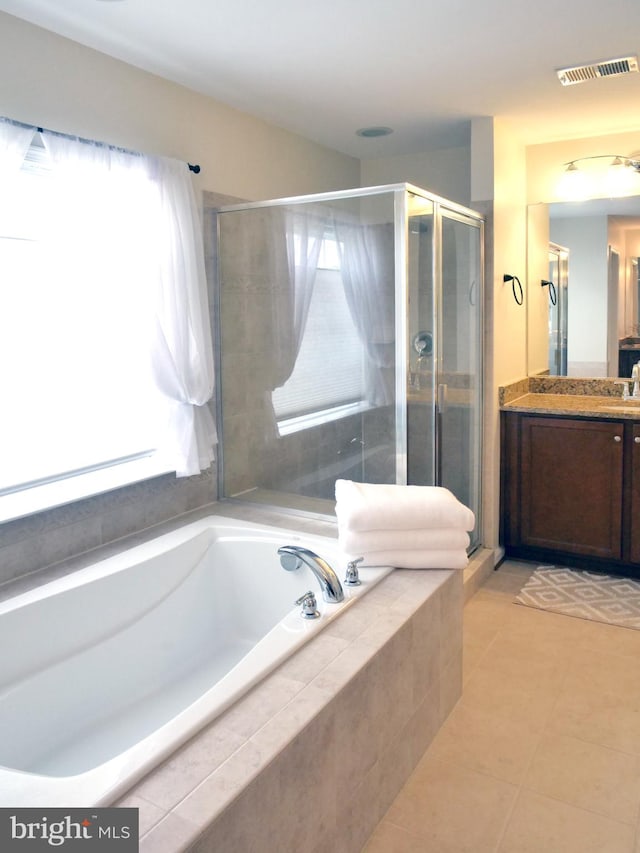 15152 Santander Dr, Gainesville, VA 20155 - full bath featuring vanity, a bath, tile patterned flooring, and a stall shower