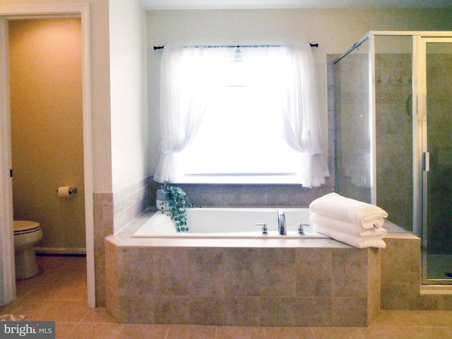 15152 Santander Dr, Gainesville, VA 20155 - bathroom featuring healthy amount of natural light, tile patterned floors, a garden tub, and a stall shower