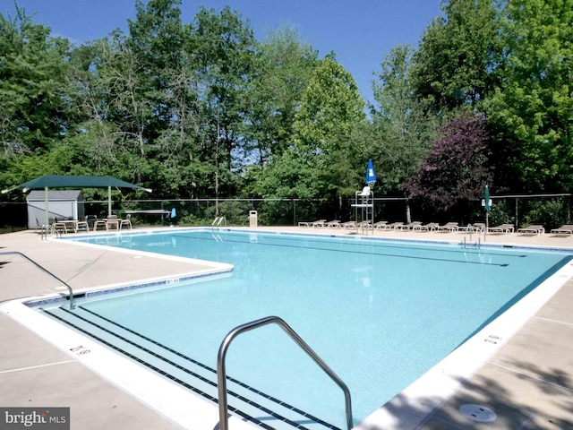 15152 Santander Dr, Gainesville, VA 20155 - community pool featuring a patio and view of scattered trees