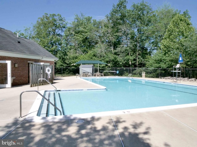 15152 Santander Dr, Gainesville, VA 20155 - community pool featuring a patio and view of scattered trees