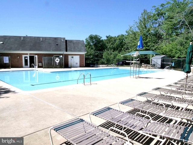 15152 Santander Dr, Gainesville, VA 20155 - community pool with a patio and an outbuilding