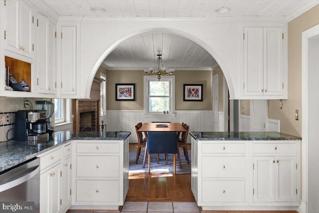 200 Sweetbriar, Winchester, VA 22603 - kitchen with dishwasher, arched walkways, a peninsula, wainscoting, and wooden ceiling