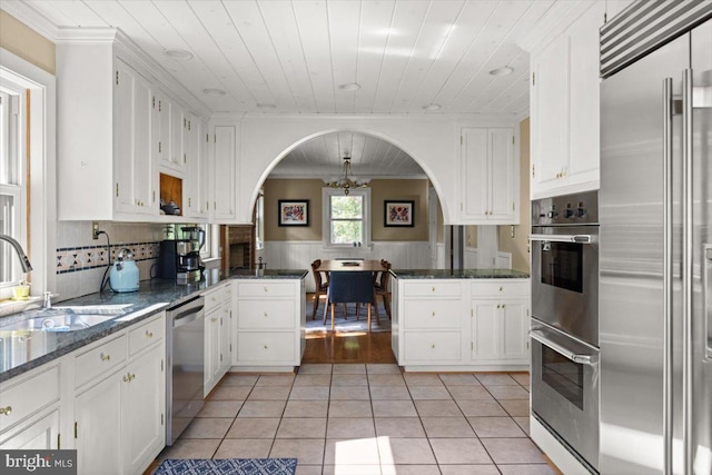 200 Sweetbriar, Winchester, VA 22603 - kitchen featuring stainless steel appliances, a peninsula, light tile patterned floors, white cabinets, and wood ceiling