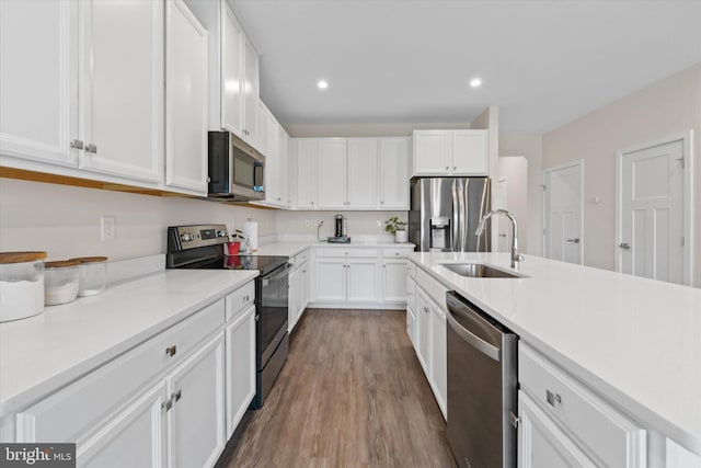 346 Goodwick Dr, Middletown, DE 19709 - kitchen with stainless steel appliances, white cabinets, dark wood-type flooring, and recessed lighting