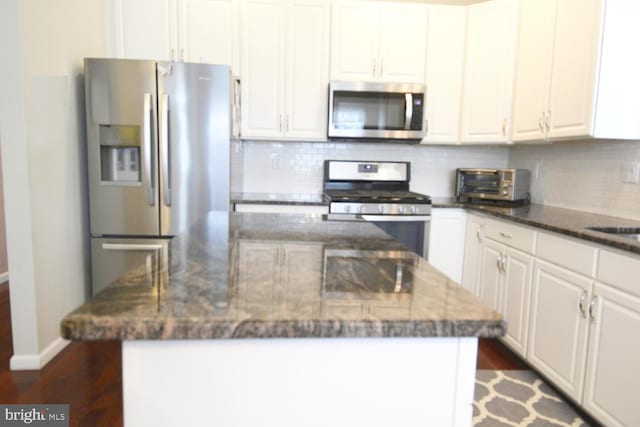 12 Atrium Dr, Trenton, NJ 08620 - kitchen with appliances with stainless steel finishes, dark wood-style floors, tasteful backsplash, a center island, and white cabinetry