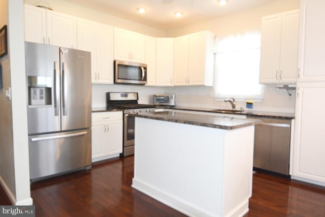 12 Atrium Dr, Trenton, NJ 08620 - kitchen with stainless steel appliances, white cabinets, dark wood-style flooring, a center island, and dark stone counters