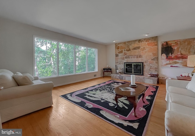 12987 Holly Way, Lusby, MD 20657 - living room with wood finished floors and a stone fireplace