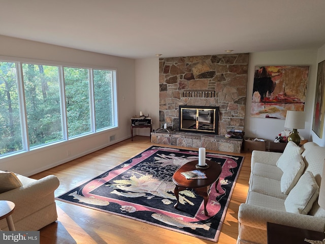 12987 Holly Way, Lusby, MD 20657 - living room with a stone fireplace and wood finished floors