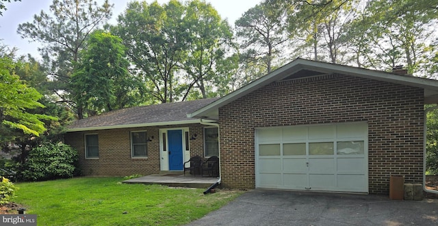 12987 Holly Way, Lusby, MD 20657 - ranch-style house with asphalt driveway, brick siding, a garage, and a front yard