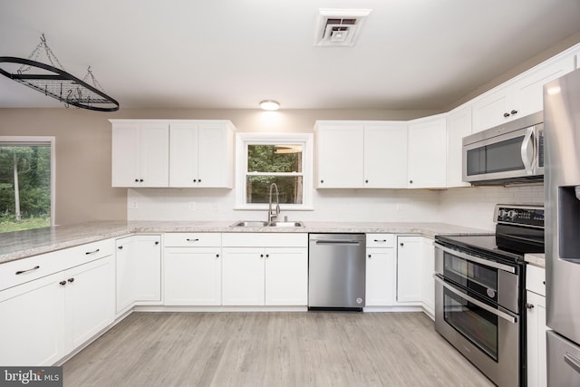 7043 Cromwell Ave, Salisbury, MD 21804 - kitchen featuring stainless steel appliances, white cabinetry, and plenty of natural light