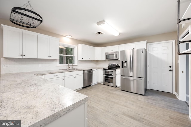 7043 Cromwell Ave, Salisbury, MD 21804 - kitchen featuring stainless steel appliances, light countertops, light wood-style floors, and tasteful backsplash