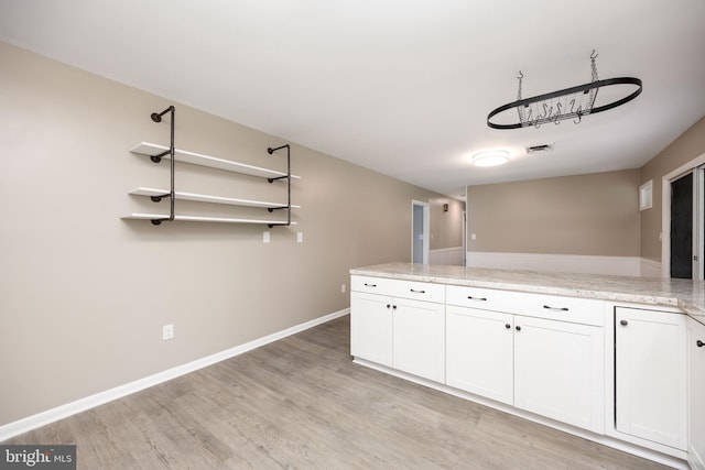 7043 Cromwell Ave, Salisbury, MD 21804 - kitchen with light wood-style flooring, white cabinets, and open shelves