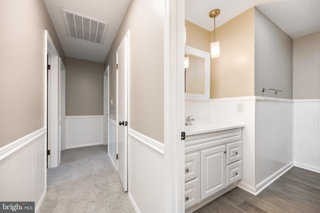 7043 Cromwell Ave, Salisbury, MD 21804 - corridor featuring wainscoting and a sink