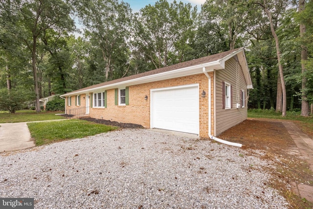 7043 Cromwell Ave, Salisbury, MD 21804 - single story home featuring brick siding, a garage, driveway, and view of wooded area