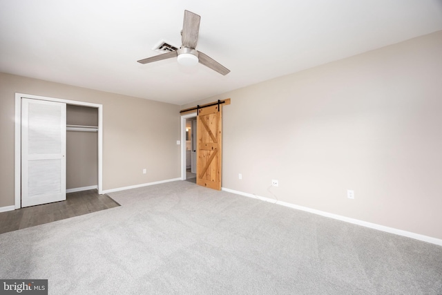 7043 Cromwell Ave, Salisbury, MD 21804 - unfurnished bedroom with a barn door, carpet, ceiling fan, and a closet