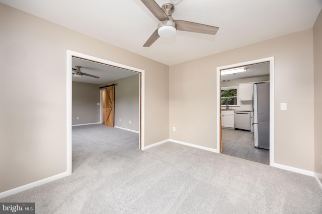 7043 Cromwell Ave, Salisbury, MD 21804 - unfurnished room featuring a barn door, light colored carpet, and a ceiling fan