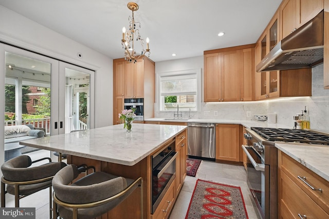 1646 Foxhall Rd NW, Washington, DC 20007 - kitchen featuring stainless steel appliances, extractor fan, backsplash, a breakfast bar, and light stone counters