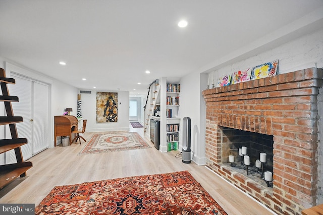 1646 Foxhall Rd NW, Washington, DC 20007 - living area with wood finished floors, a brick fireplace, and recessed lighting