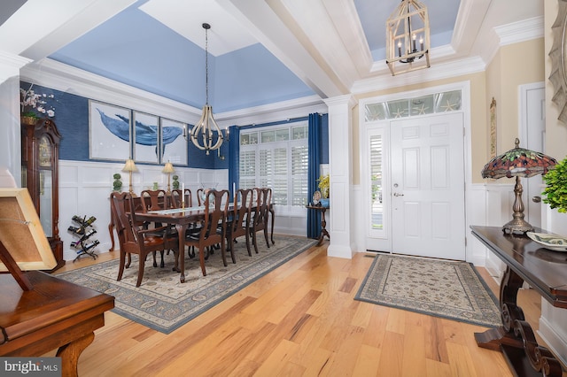 35213 Overfalls Dr N, Lewes, DE 19958 - foyer featuring a chandelier, a decorative wall, ornamental molding, wood finished floors, and wainscoting