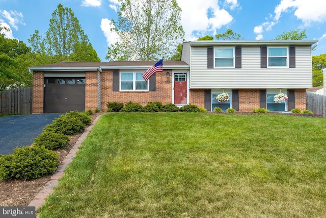 4328 Rolling Stone Way, Alexandria, VA 22306 - tri-level home with asphalt driveway, brick siding, and an attached garage