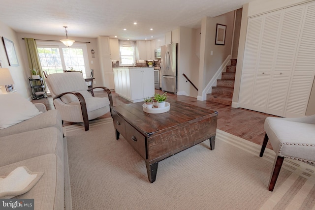 4328 Rolling Stone Way, Alexandria, VA 22306 - living room with plenty of natural light, recessed lighting, stairway, and light wood-type flooring