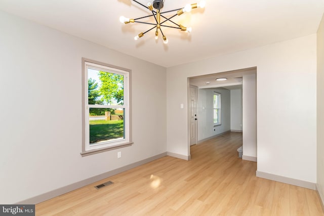 43 Vernon Ct, Sicklerville, NJ 08081 - unfurnished room featuring plenty of natural light, a chandelier, and light wood-type flooring