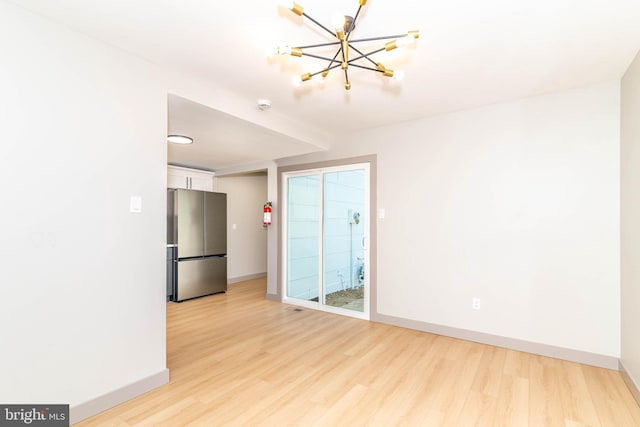43 Vernon Ct, Sicklerville, NJ 08081 - unfurnished room with light wood finished floors, a chandelier, and a smoke detector