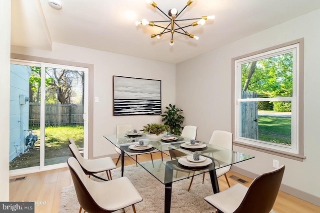 43 Vernon Ct, Sicklerville, NJ 08081 - dining space with a chandelier, healthy amount of natural light, and light wood finished floors