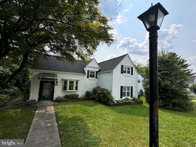 6517 Lehnert St, Baltimore, MD 21207 - view of front facade featuring a front lawn and roof with shingles