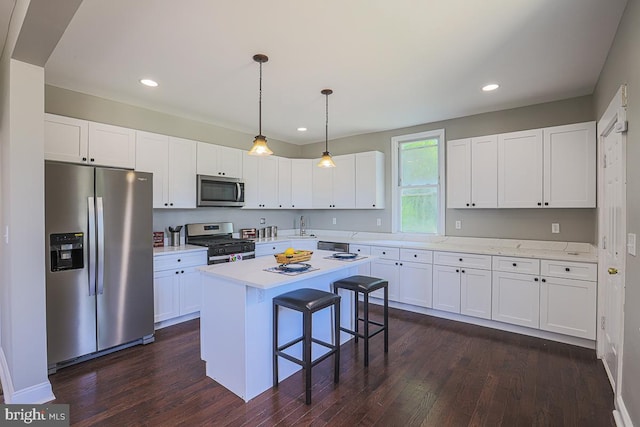 4001 Ridgecroft Rd, Baltimore, MD 21206 - kitchen featuring stainless steel appliances, a breakfast bar, white cabinets, light countertops, and recessed lighting