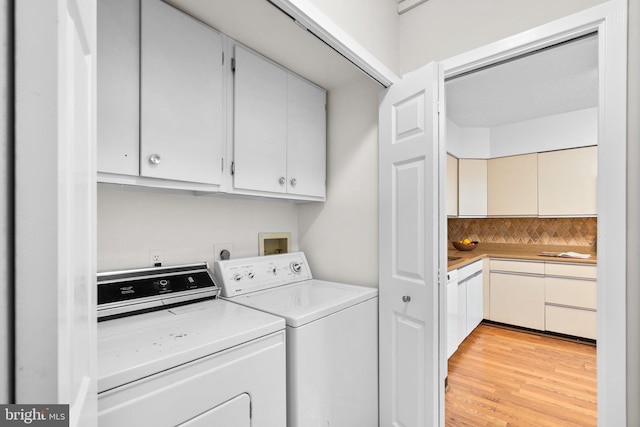 5501 Seminary Rd Unit 407S, Falls Church, VA 22041 - laundry area featuring cabinet space, washing machine and clothes dryer, and light wood-style floors