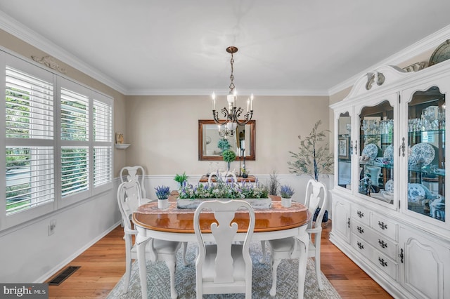 1632 Breakers Dr, Manahawkin, NJ 08050 - dining space with a chandelier, light wood-style flooring, and ornamental molding