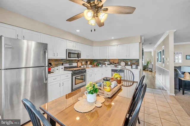 1632 Breakers Dr, Manahawkin, NJ 08050 - kitchen featuring appliances with stainless steel finishes, white cabinetry, backsplash, ornamental molding, and ceiling fan