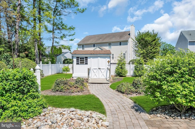 1632 Breakers Dr, Manahawkin, NJ 08050 - rear view of property featuring a storage shed, a fenced backyard, and a chimney