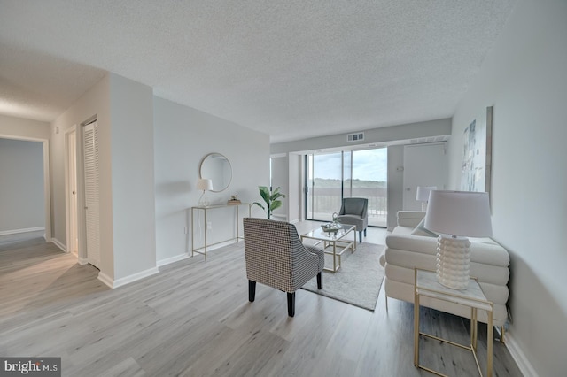 5300 Holmes Run Pkwy Unit 709, Alexandria, VA 22304 - living area with wood finished floors and a textured ceiling