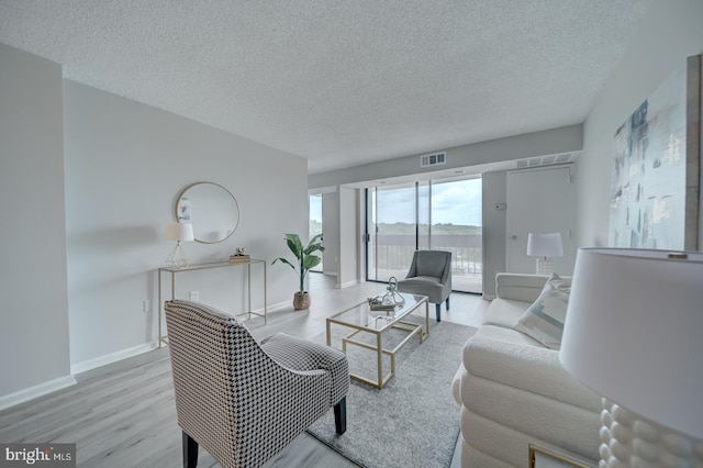 5300 Holmes Run Pkwy Unit 709, Alexandria, VA 22304 - living area featuring a textured ceiling and wood finished floors