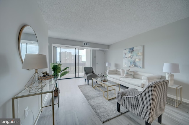 5300 Holmes Run Pkwy Unit 709, Alexandria, VA 22304 - living area with wood finished floors and a textured ceiling
