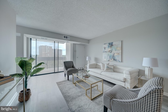 5300 Holmes Run Pkwy Unit 709, Alexandria, VA 22304 - living room with a textured ceiling and wood finished floors