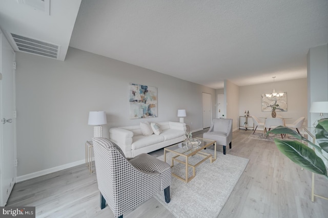5300 Holmes Run Pkwy Unit 709, Alexandria, VA 22304 - living room featuring light wood-style flooring and a chandelier