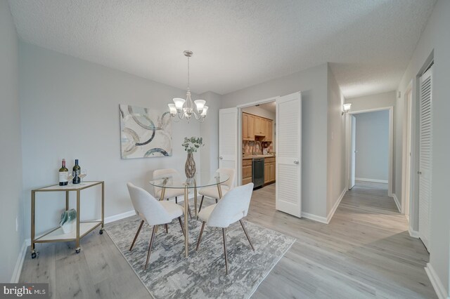 5300 Holmes Run Pkwy Unit 709, Alexandria, VA 22304 - dining space featuring light wood finished floors, a chandelier, and a textured ceiling