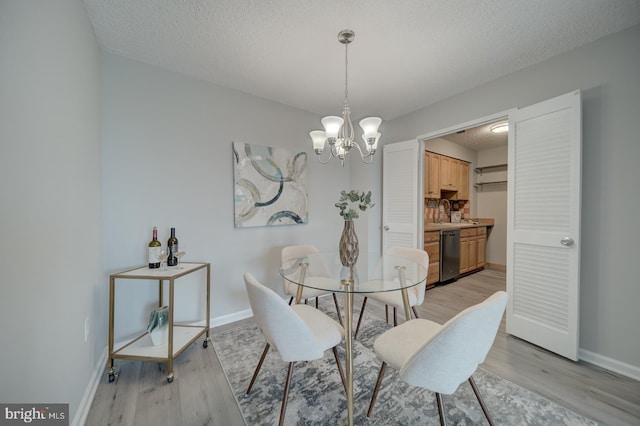 5300 Holmes Run Pkwy Unit 709, Alexandria, VA 22304 - dining area with a chandelier, light wood-style floors, and a textured ceiling