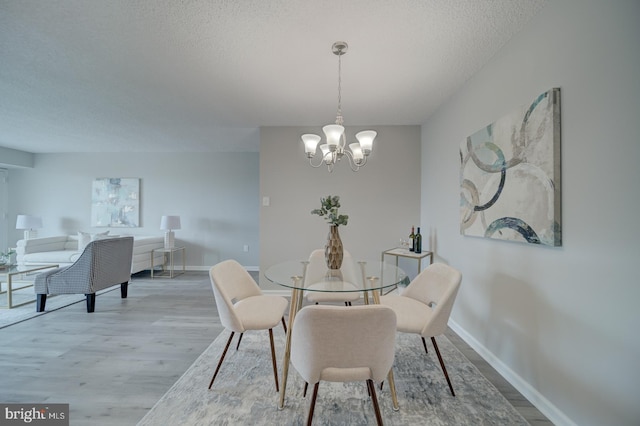 5300 Holmes Run Pkwy Unit 709, Alexandria, VA 22304 - dining room featuring a textured ceiling, wood finished floors, and a chandelier