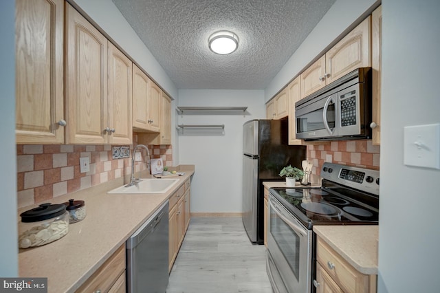 5300 Holmes Run Pkwy Unit 709, Alexandria, VA 22304 - kitchen with stainless steel appliances, light brown cabinets, a textured ceiling, light wood-style floors, and decorative backsplash